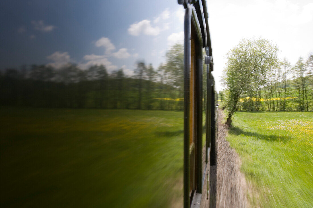 View from a window of an excursion train, Rhoen-Zuegle between Fladungen and Ostheim, Rhoen, Bavaria, Germany