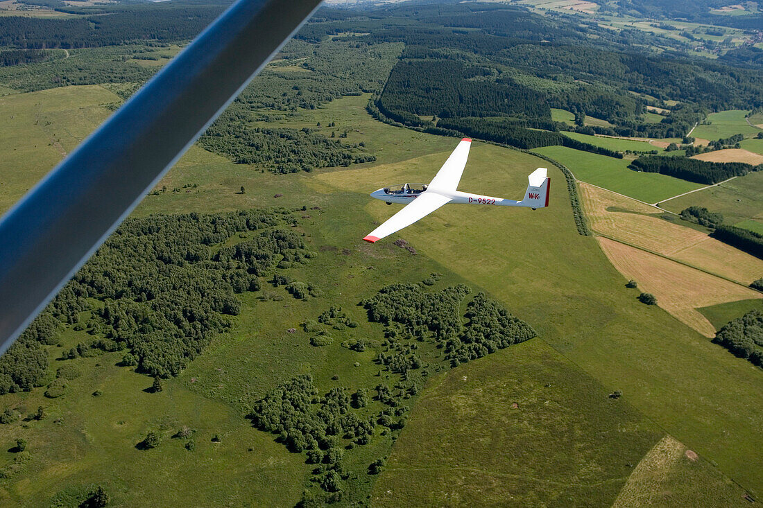 Aerial photo of a glider airplane over the Rhoen Region, Near Wasserkuppe Mountain, Rhoen, Hesse, Germany