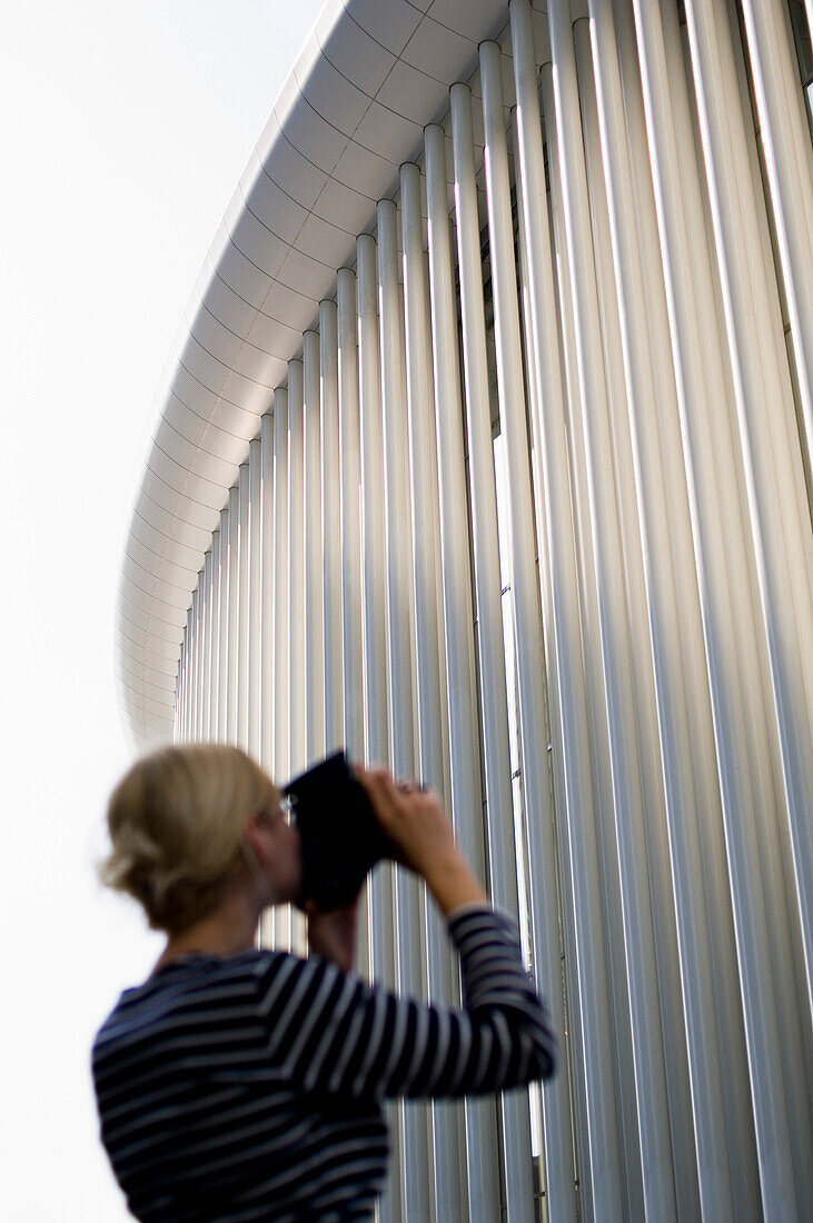 Young woman photographing Philarmonie, Luxembourg, Luxembourg