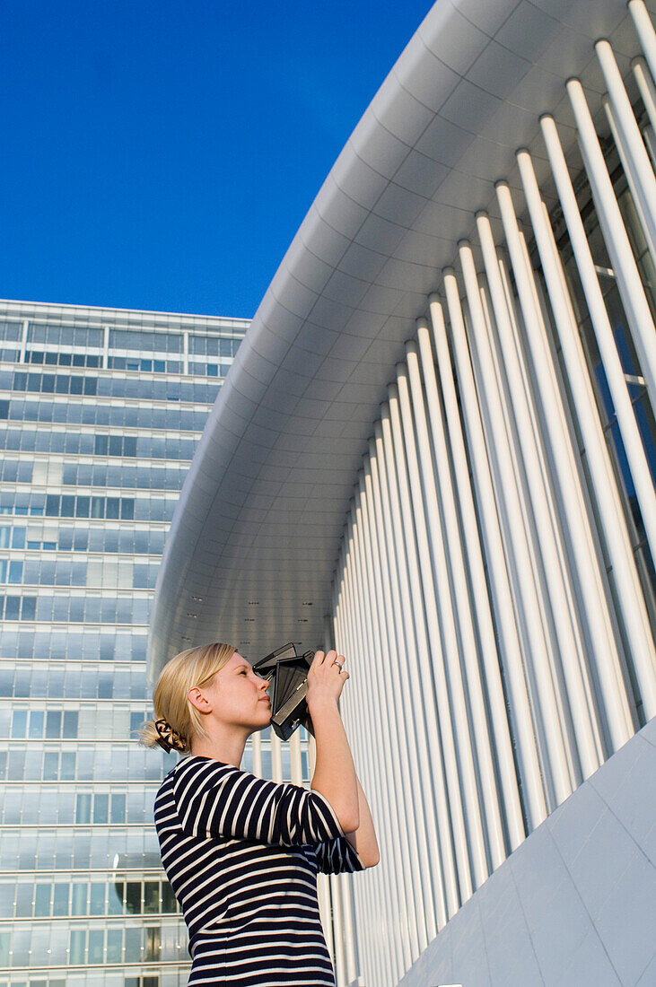 Woman taking picture of building, Luxembourg
