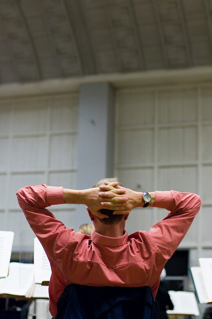 A man sitting in the rehearsal room of the symphonic orchestra, Munich, Bavaria, Germany
