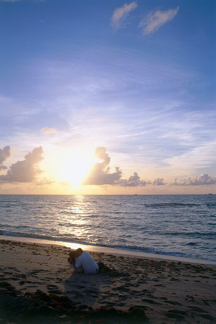 Sun-rise with love couple on beachfront, South Beach, Miami, Florida, USA