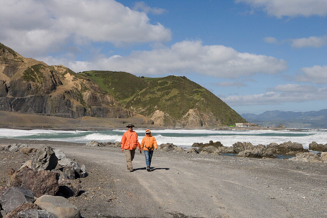 Two Hikers on the Red Rocks Coastal Walk, Owhiro Bay, near Wellington, North Island, New Zealand