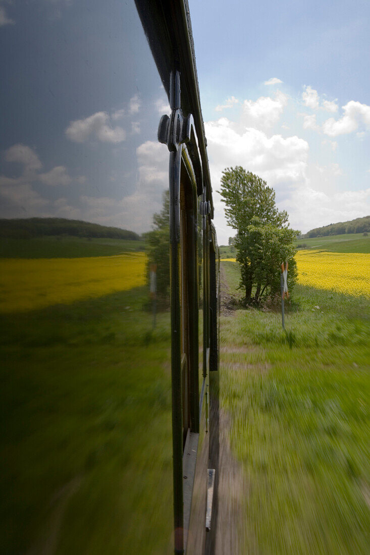 View out of a window from Excursion Train, Rhoen-Zuegle between Fladungen and Ostheim, Rhoen, Bavaria, Germany