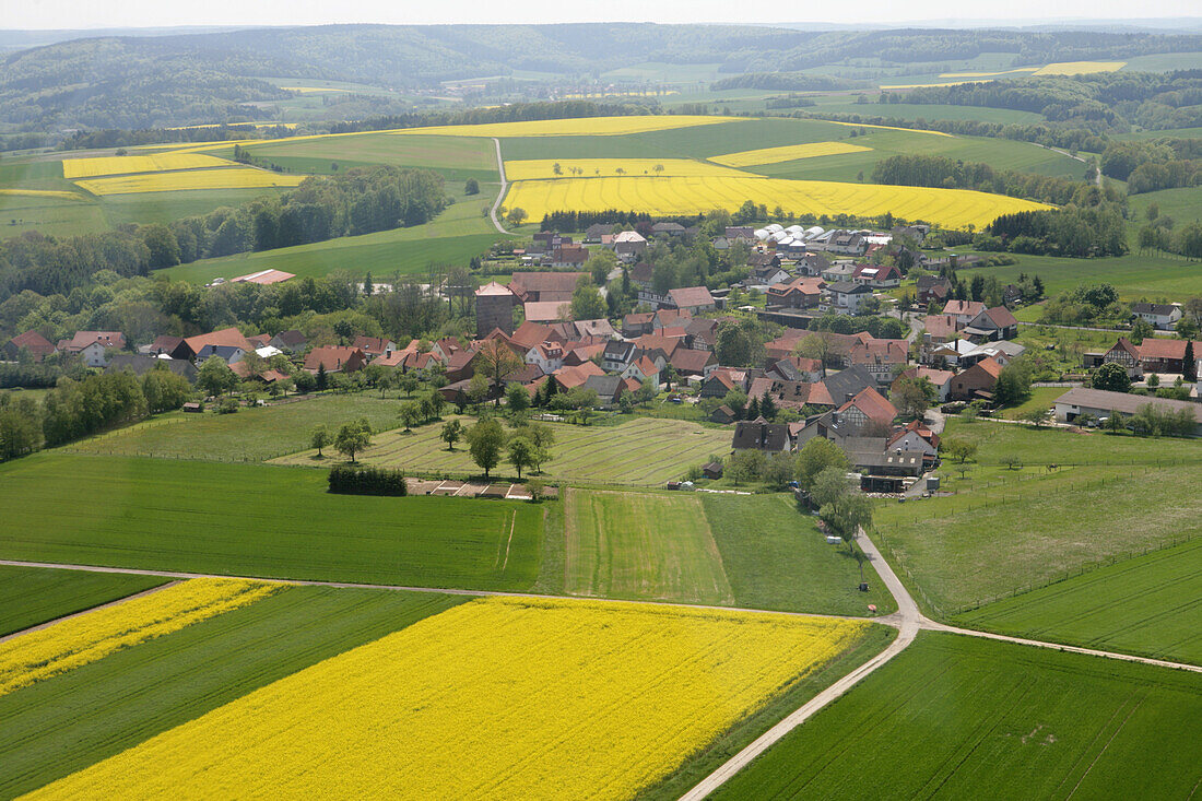 Aerial Photo of Village and Canola Fields, Haunetal Holzheim, Rhoen, Hesse, Germany