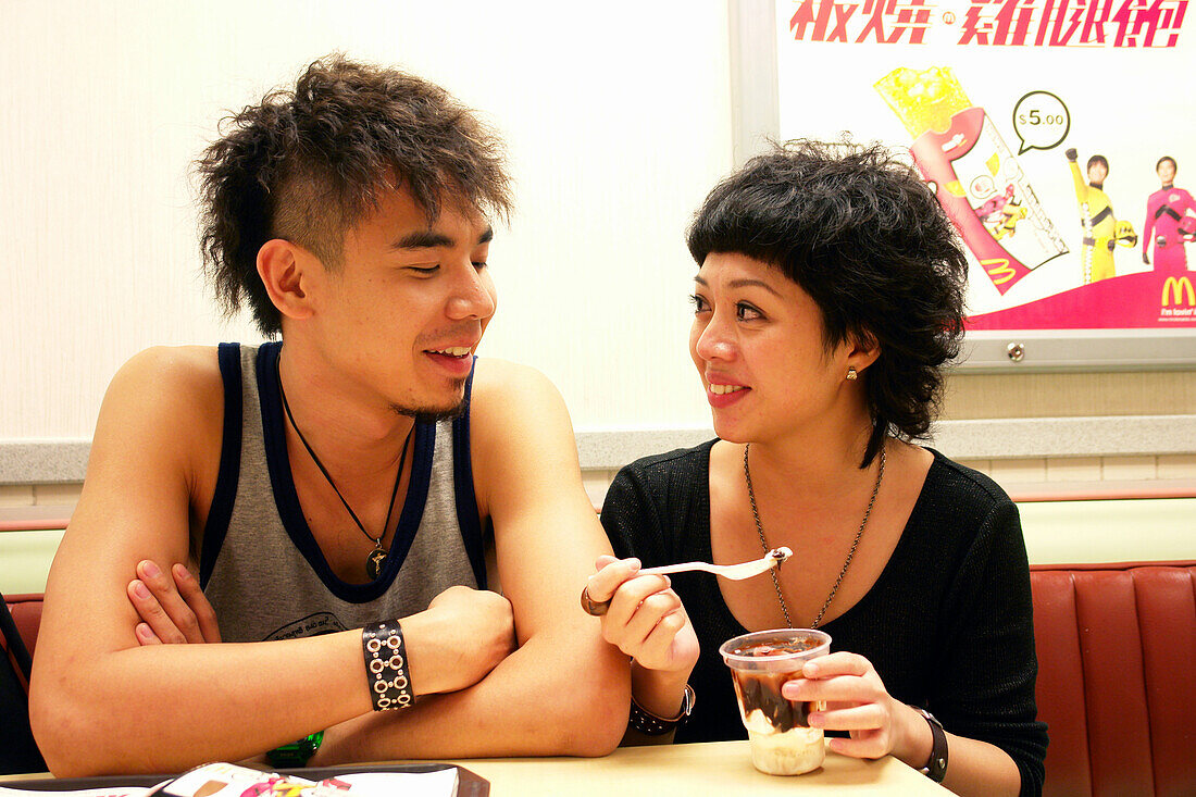Young Couple in a fast food restaurant. Hong Kong, China