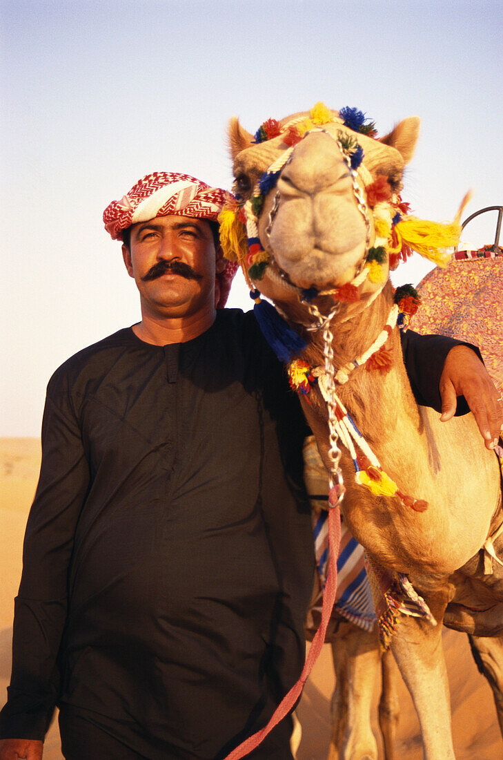 A local man, Bedouin, with camel, Desert, Dubai, United Arab Emirates