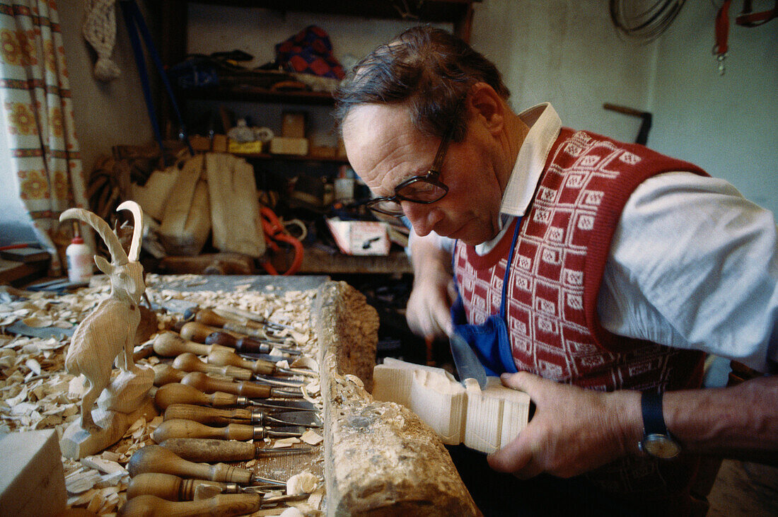 Wood Carver carving wood, Ortisei, Gardena, South Tyrol, Italy