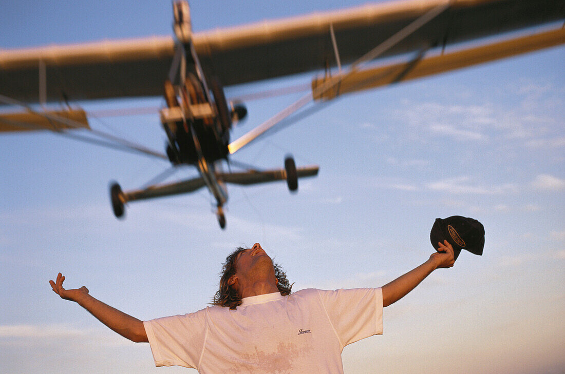 Mircolight plane flying over a person, airplane flying over an airport, Fly Ranch, Buenos Aires, Argentina