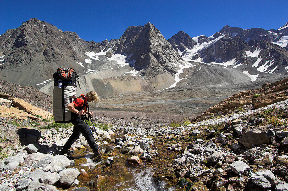 Man ascending a mountain via Cajon del Maipo towards Cerro Marmolejo, 6085 m, South Face, Ice Climbing, Chile