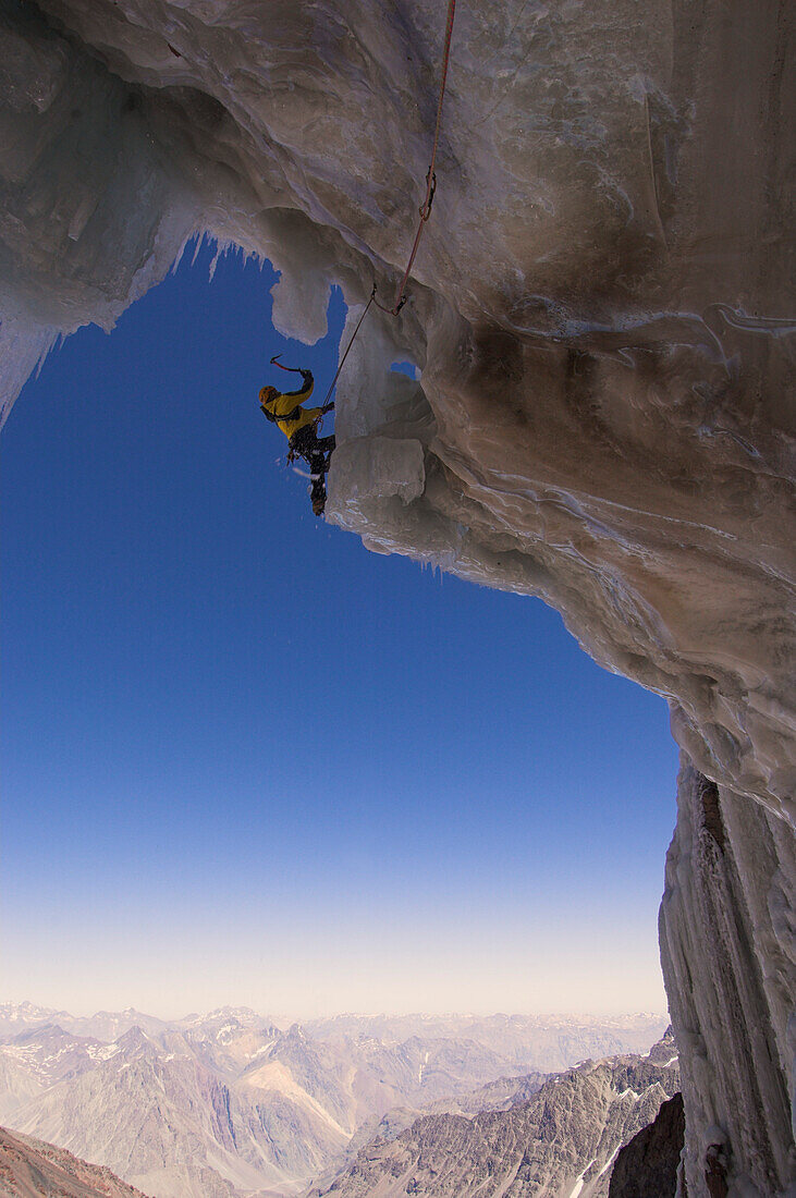 Ice climber on icy rock face, mount Cerro Marmolejo, Andes, Chile