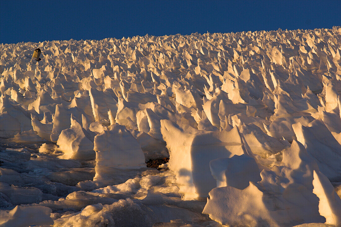 Man walking through snow formations on the plateau of Cerro Marmolejo, 6085 m, Chile