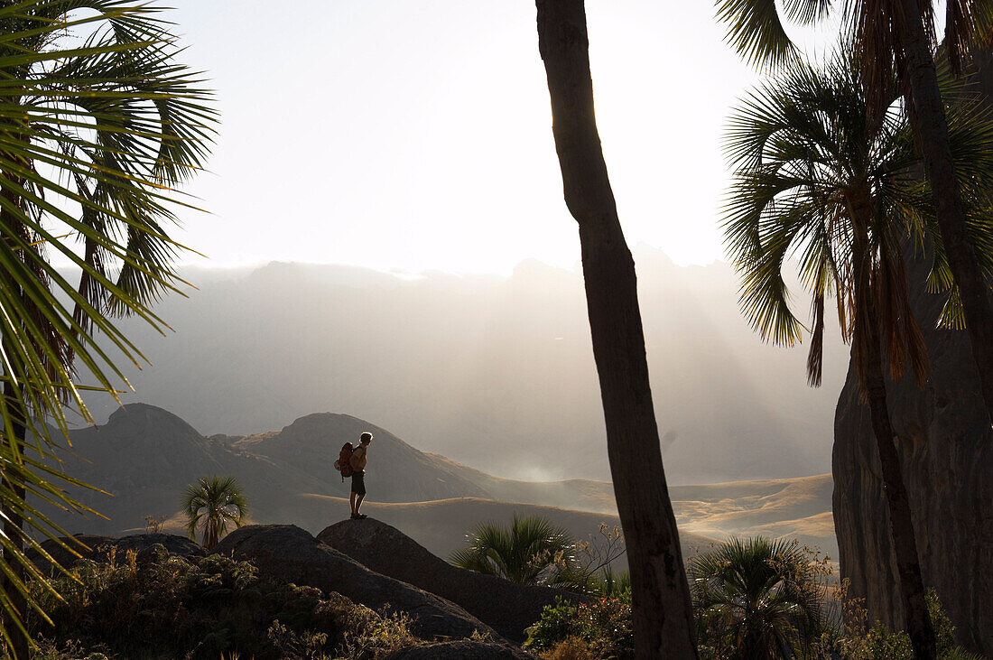 Hiker with backbag in misty landscape, Madagascar