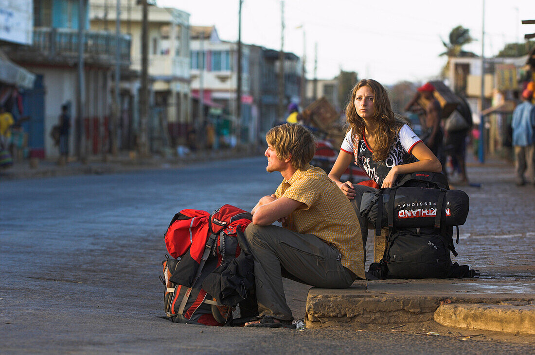 A couple waiting for transport, Madagascar, Africa