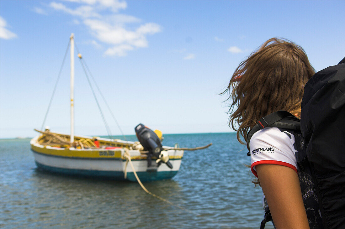 Young woman with backback waiting for boat