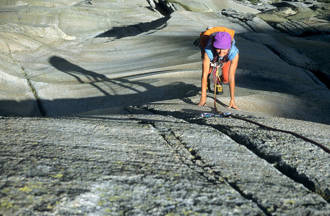 Climber on granite rock face, Grimsel Pass, Switzerland