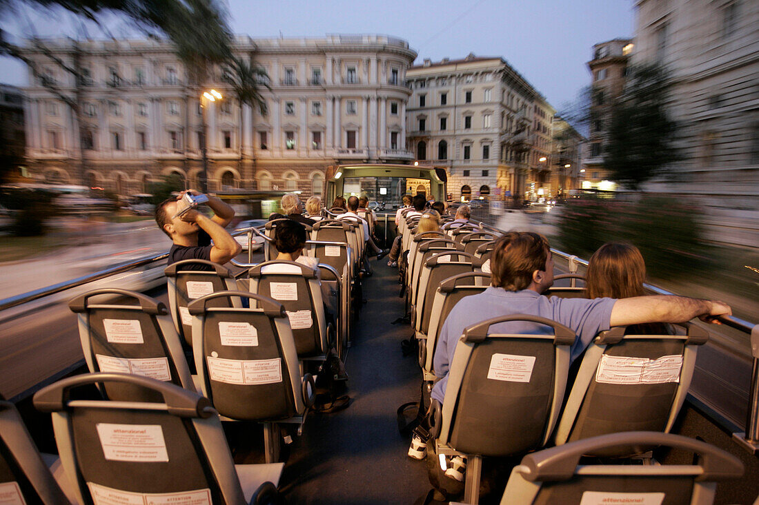 Tourists on the upper deck of a sightseeing bus, Rome, Italy