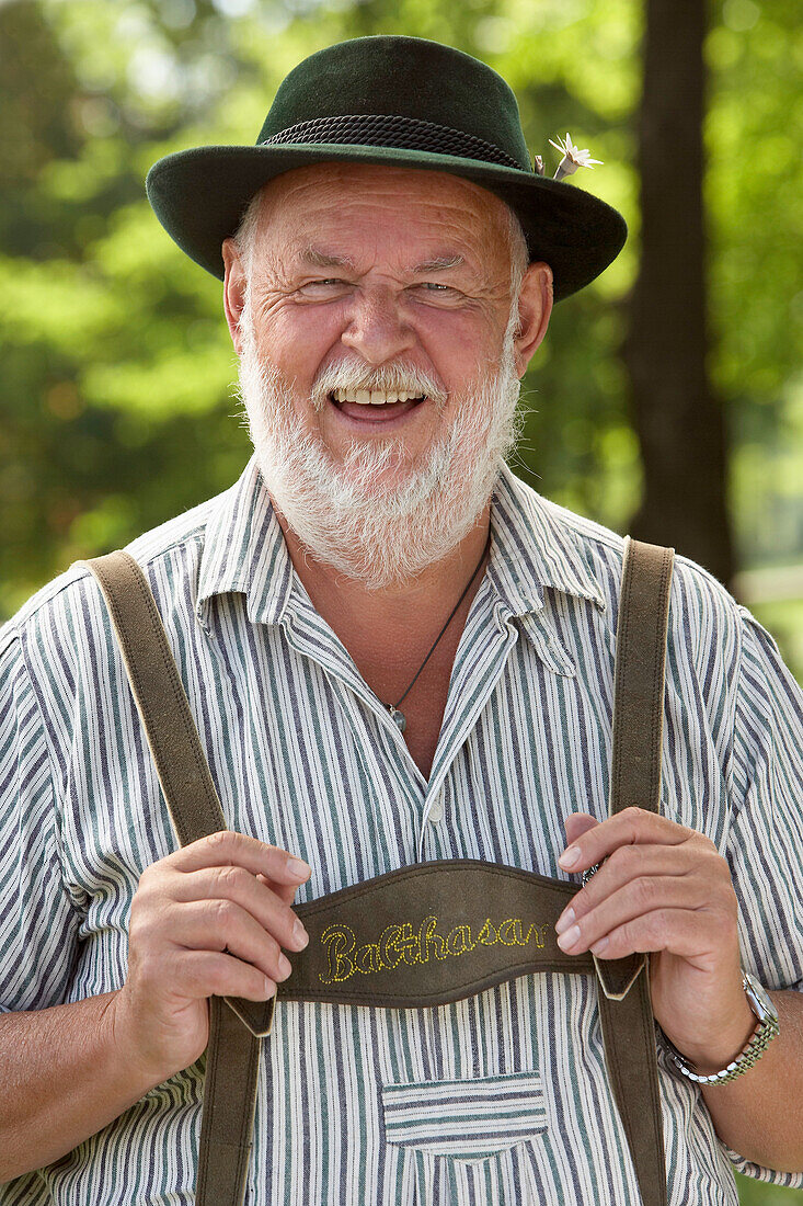 Mature man laughing at camera