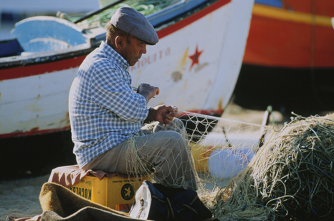 Fisherman repairing net, Albufeira, Portugal