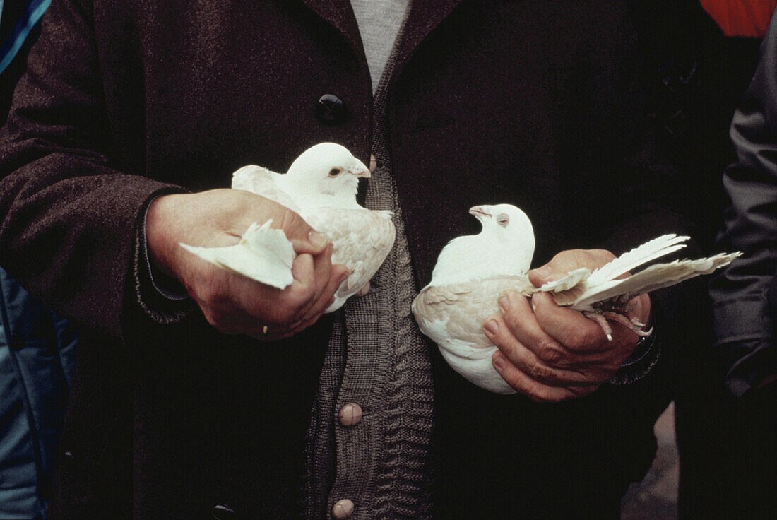 Man holding doves