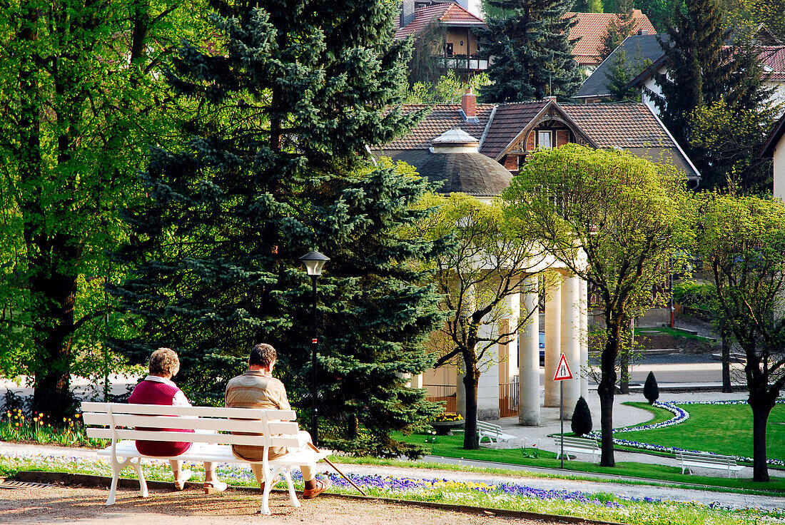 Bench with elderly couple in the park at Bad Liebenstein, Thuringia, Germany