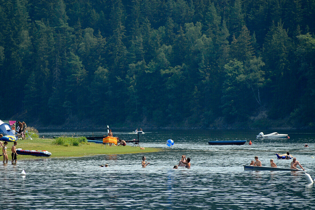 People bathing in Hohenwart lake near Linkenmuehle, Thuringia, Germany