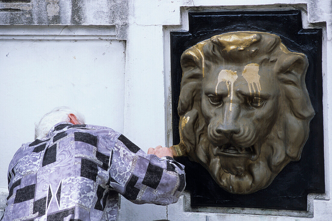 Man repainting Golden Lion, Dendrarium Botanical Garden, Sochi, Russia
