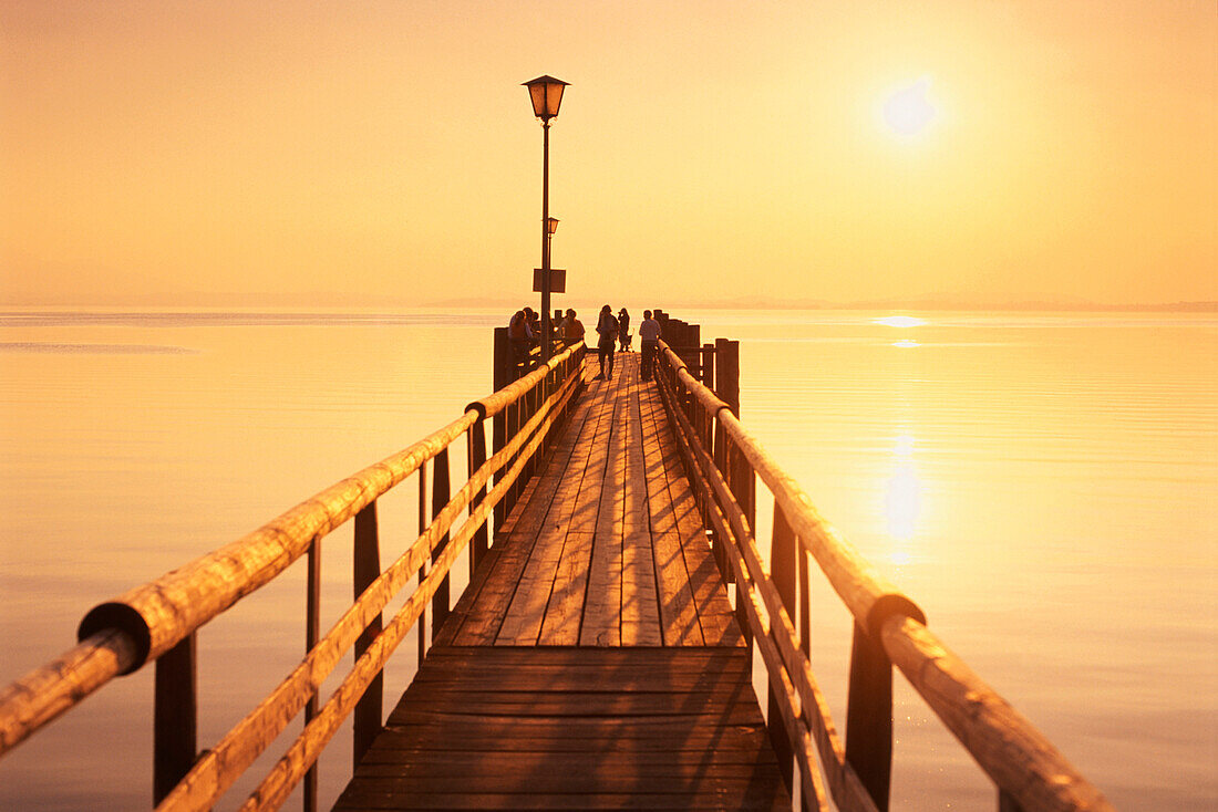 Jetty in sunset, Lake Chiem, Chieming, Chiemgau, Bavaria, Germany