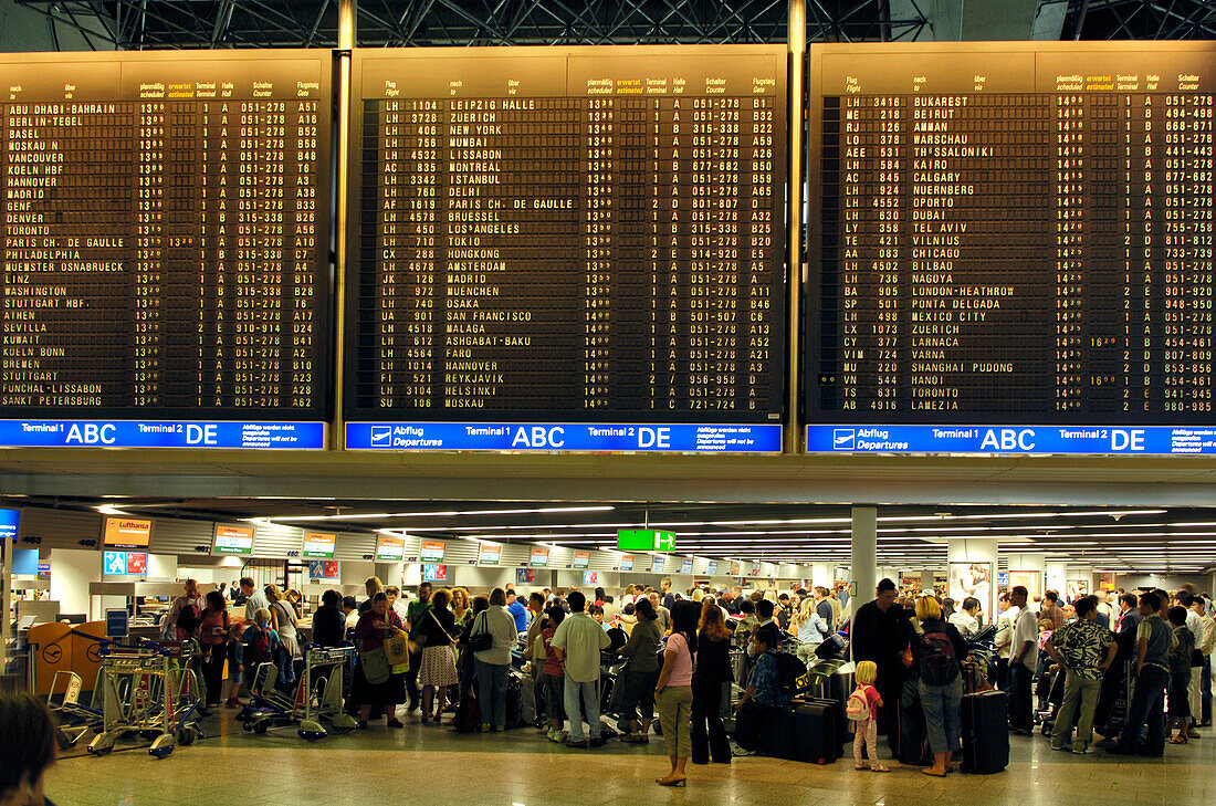 People, Travellers waiting at the flight information board, Frankfurt Airport, Hesse, Germany