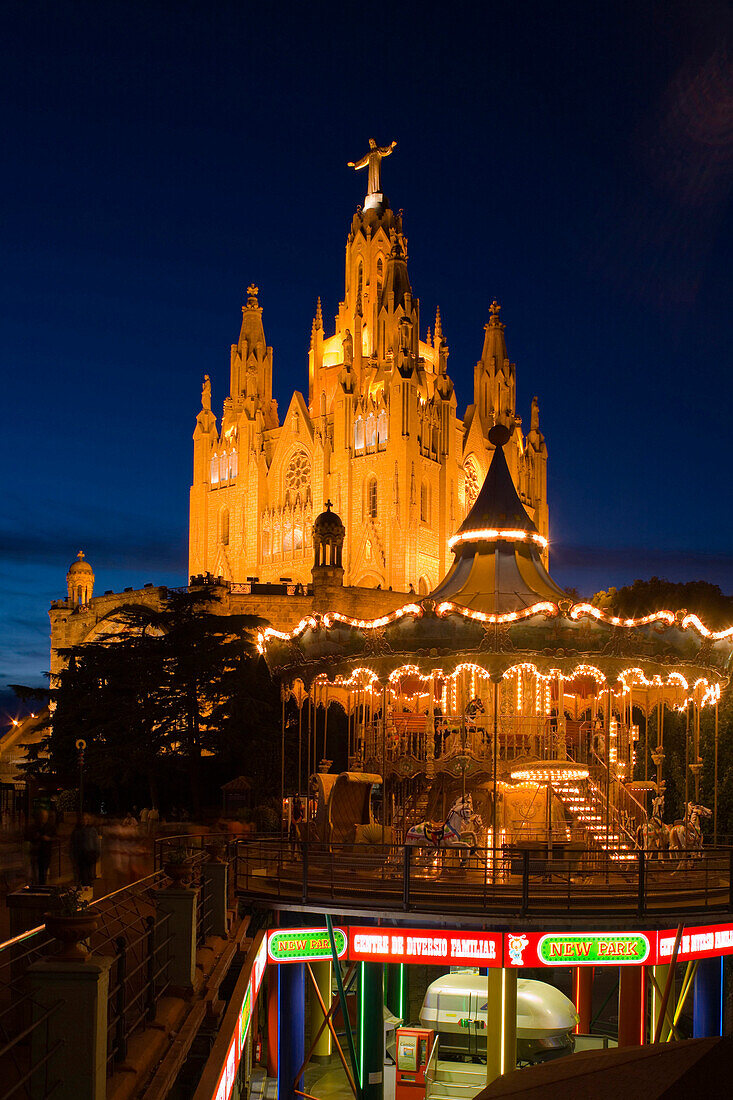 El Sagrat Cor, church, and carousel of the amusement park, Tibidabo, Barcelona, Catalonia, Spain