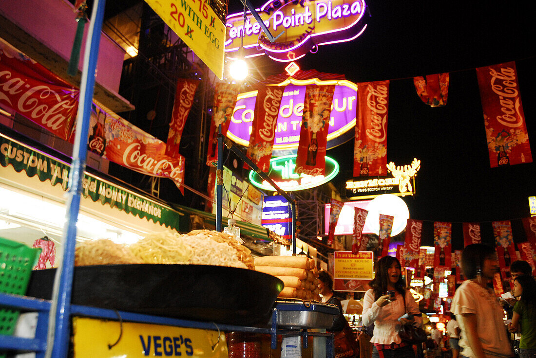Food stall selling noodles and advertisment, Khao San Road in the evening, Bangkok Thailand