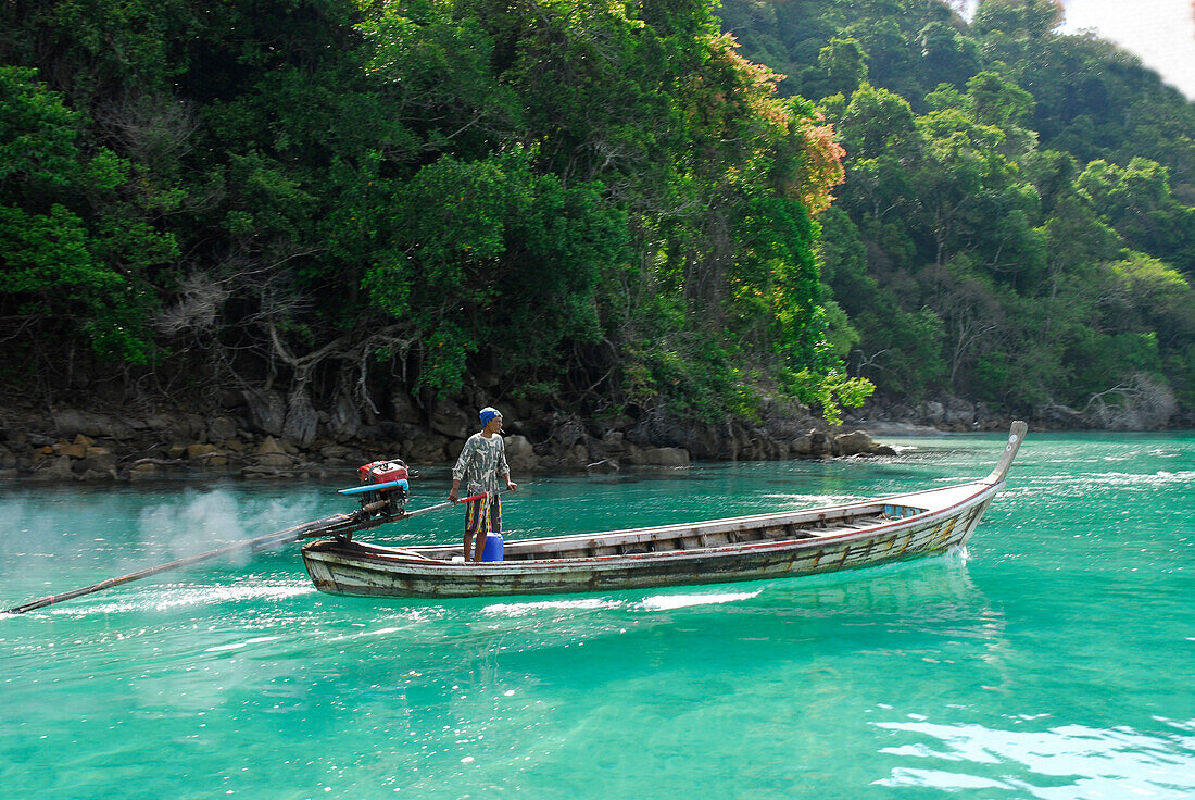 Longtail boat in front of jungle clad island, Surin Islands Marine National Park, Ko Surin, Phang Nga, Thailand