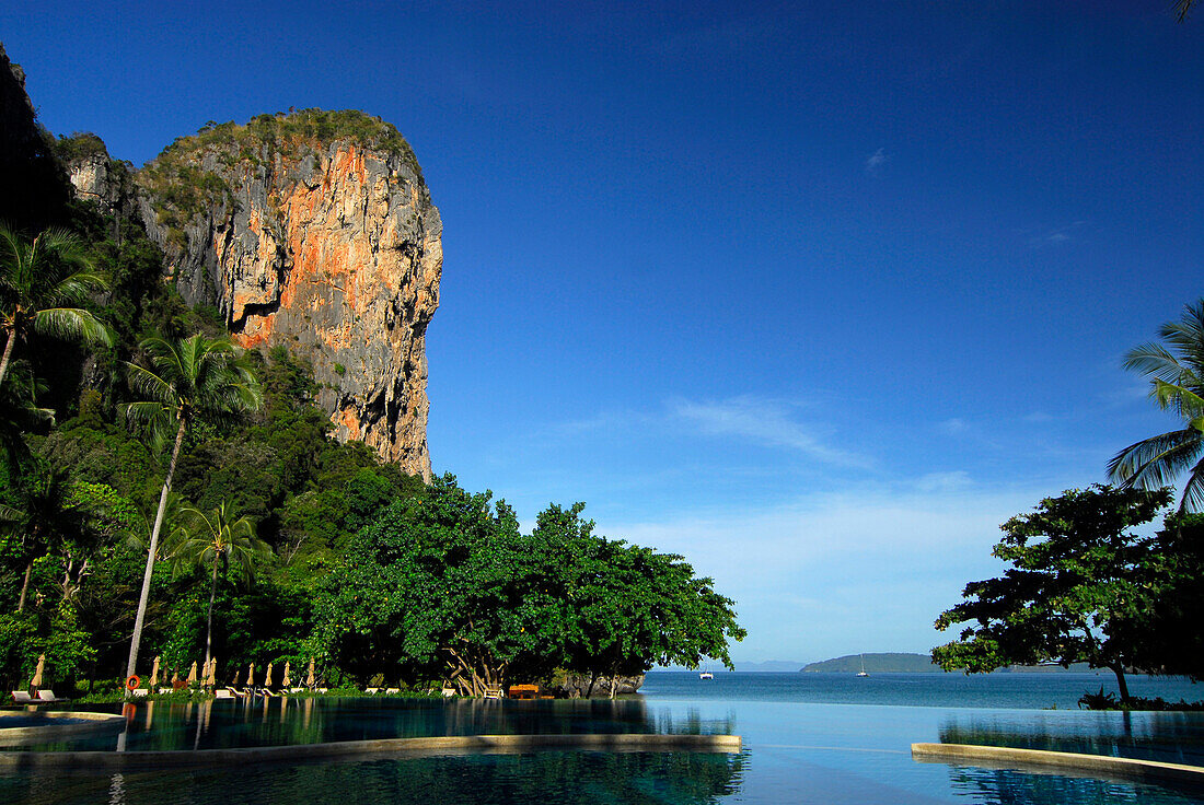 Pool in tropical garden of Hotel Rayavadee with limestone cliffs, Hat Phra Nang, Krabi, Thailand