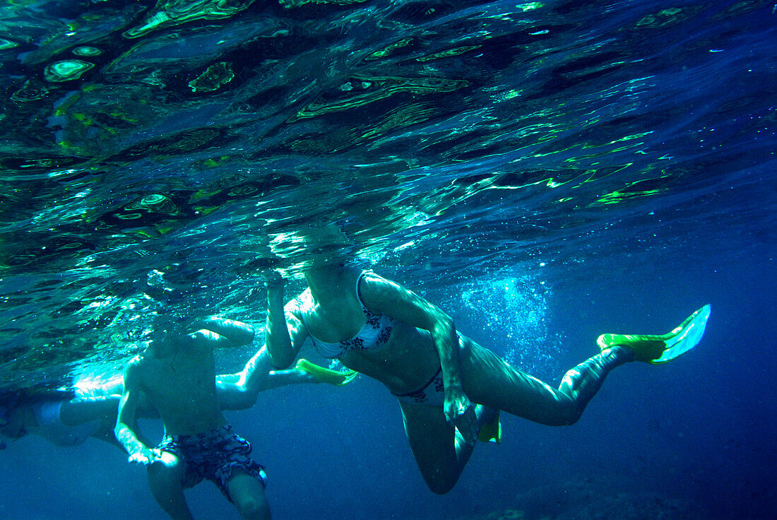 People snorkeling in clear water off Ko Surin Noi, Surin Islands Marine National Park, Ko Surin, Phang Nga, Thailand