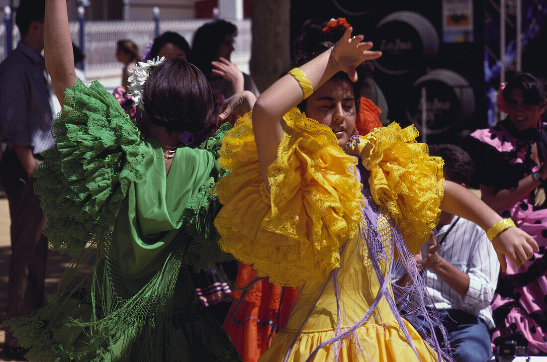 Young women in colourful frilly dresses dance Flamenco, Jerez de la Frontera, Cadiz province, Andalusia, Spain