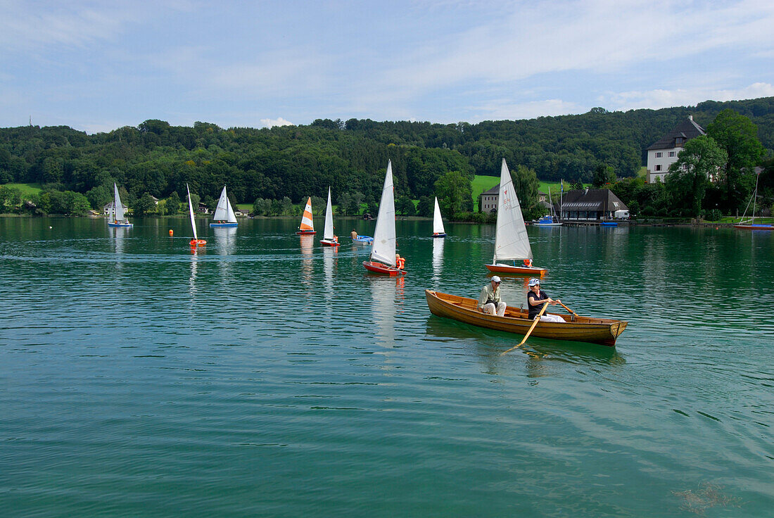 rowing boat with couple and sailing boats, lake Mattsee, Salzkammergut, Salzburg, Austria