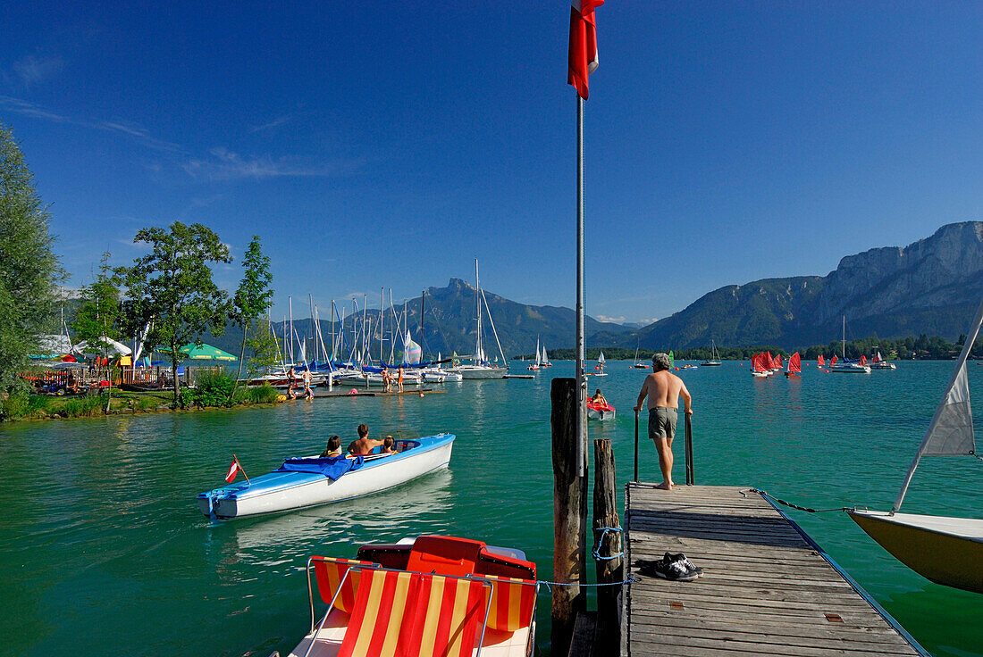 Landing stage at lake Mondsee, pedal boats and sailing boats, Salzkammergut, Salzburg, Austria