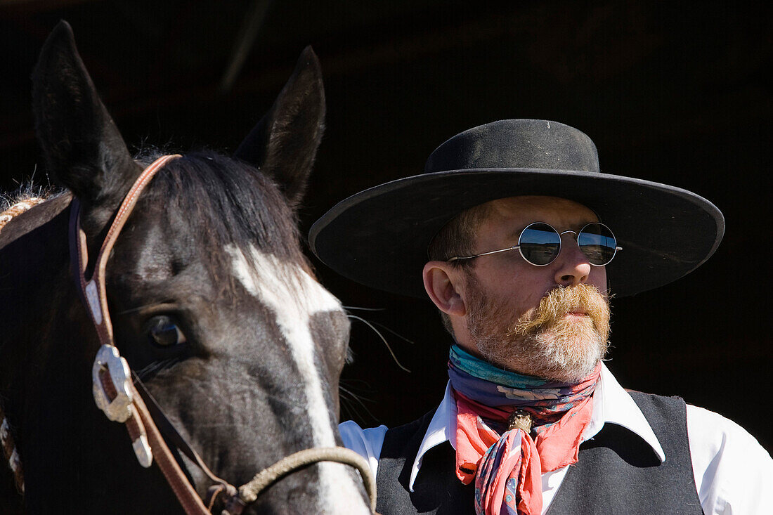 cowboy with horse at stable, wildwest, Oregon, USA