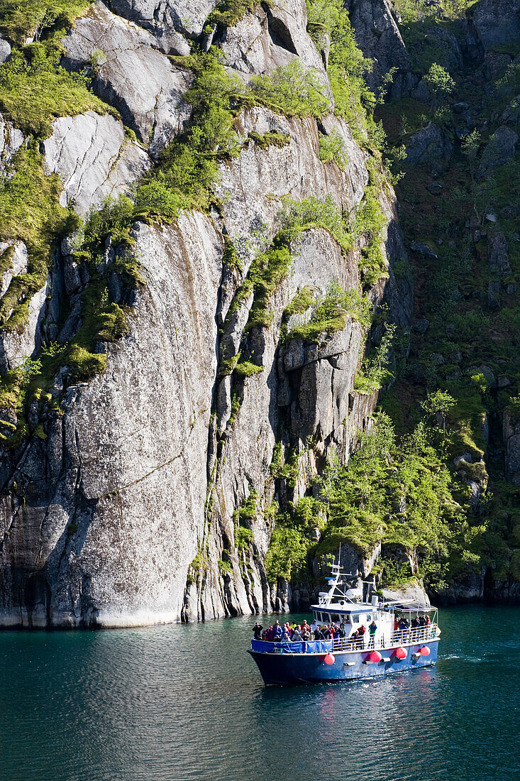 An excursion boat on a Fiord at the Island of Austvagoya, Trollfjord, Lofoten, Norway