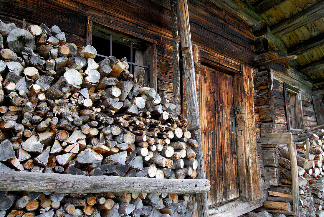 alpine hut of Kaiser Hochalm with firewood, Wilder Kaiser, Kaiser range, Tyrol, Austria