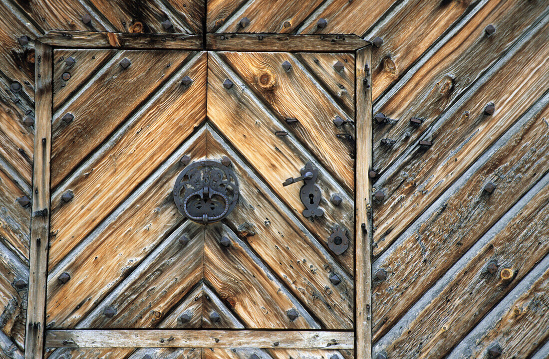 wooden front door with iron mounting, Bever, Engadin, Switzerland