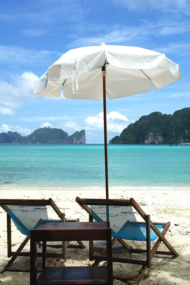 Two deck chairs and sunshade at the beach of Ko Phi Phi, Thailand, Asia