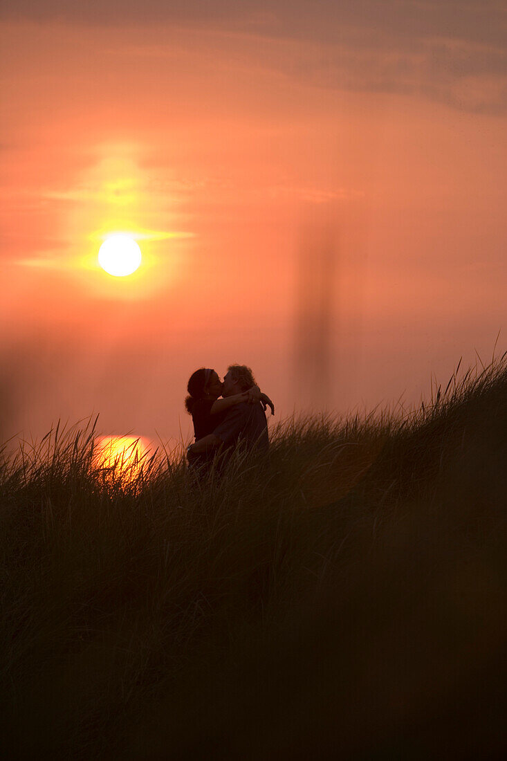 Sunset Silhouette of Romantic Couple in Dunes at Henne Strand Beach, Henne Strand, Central Jutland, Denmark