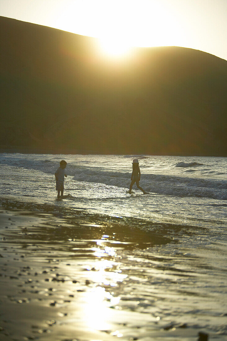 Two girls playing at beach, Port Jackson, Coromandel Peninsula, North Island, New Zealand
