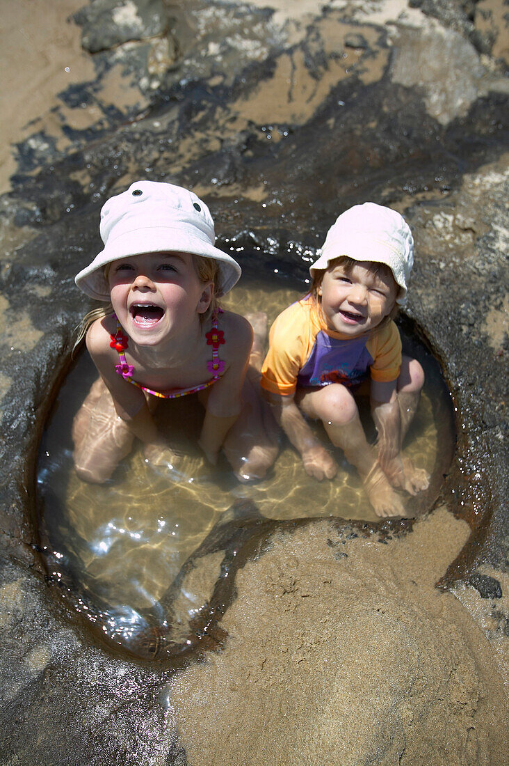 Girls bathing in waterhole, Waimamaku beach on westcoast, near Opononi, Hokianga Harbour, Northland, North Island, New Zealand