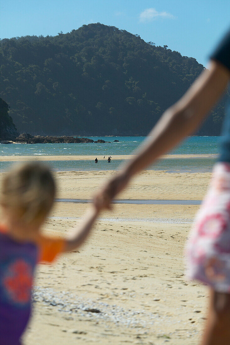 Hikink through river, Awaroa Inlet, river mouth at low tide, Abel Tasman National Park, north coast of South Island, New Zealand