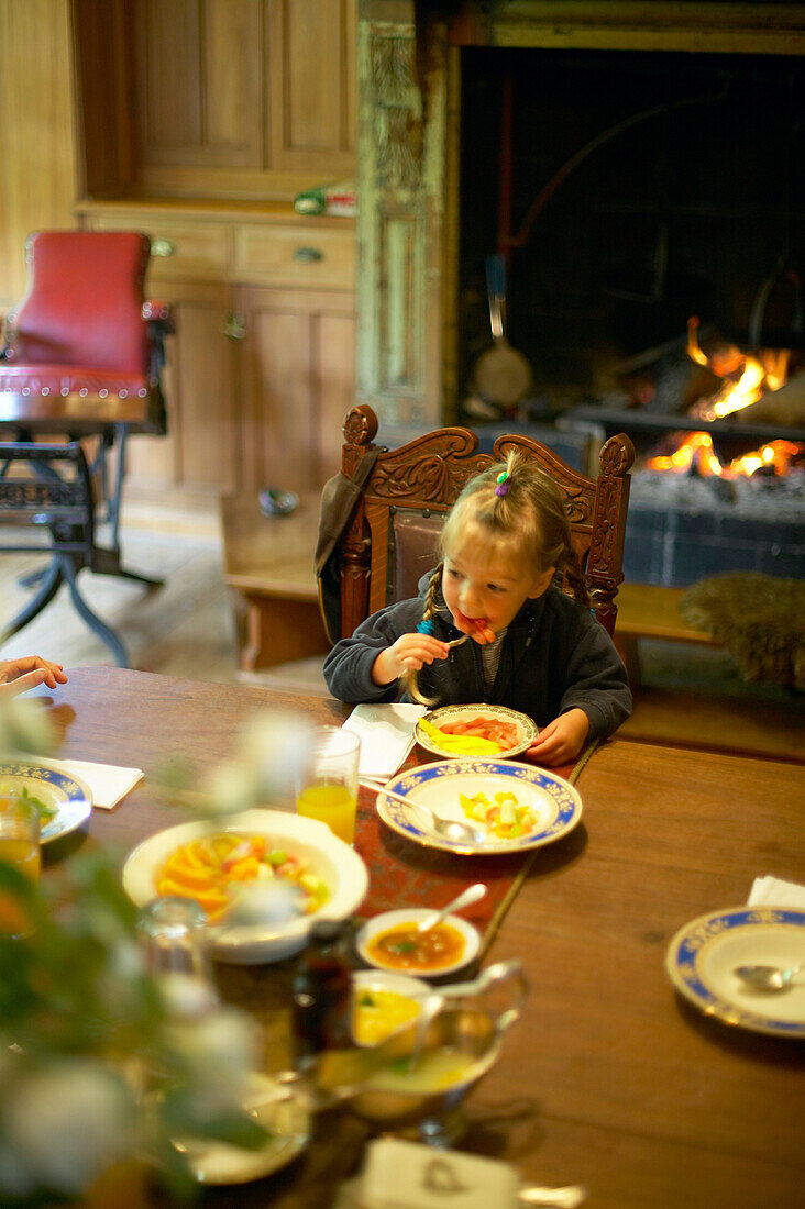 Girl at dinner, Rowendale Homestead farm, B & B, Okains Bay Bank`s Peninsula, east coast, South Island, New Zealand