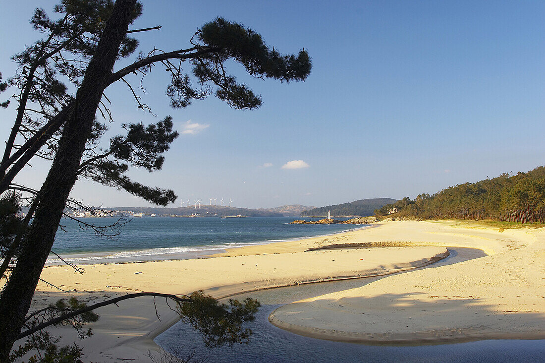 Landscape and beach with wind turbiones in the distance, bay near Leis, Ría de Camarinas, Costa da Morte, Galicia, Spain