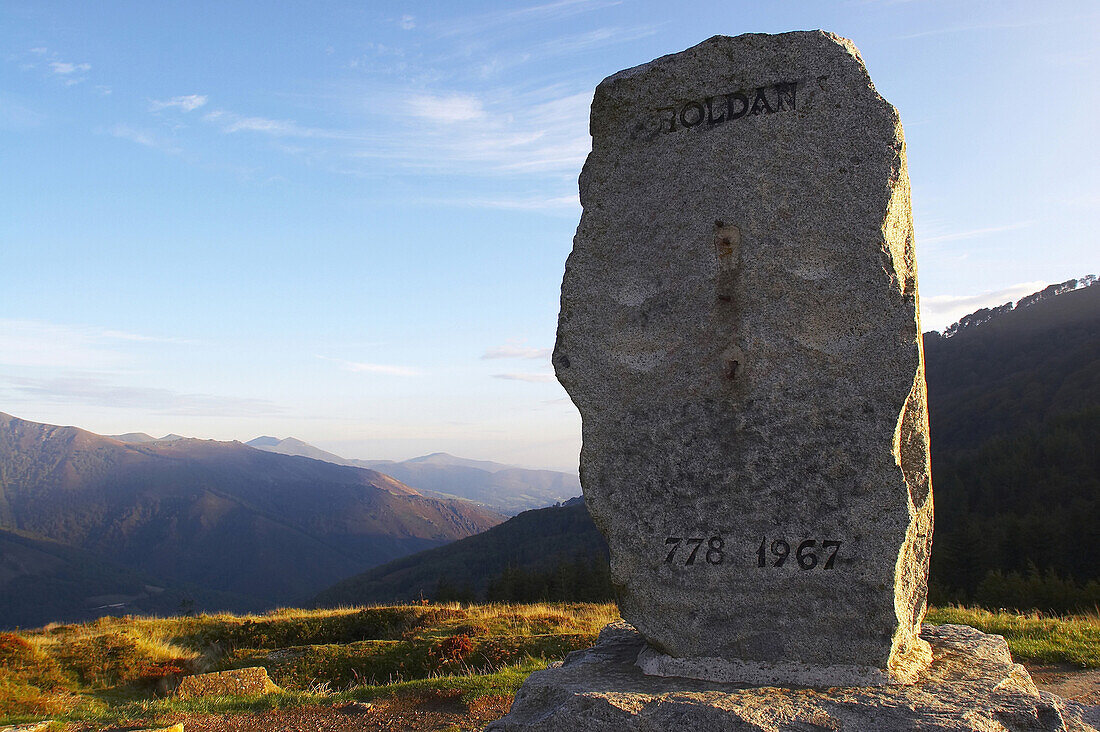 View over the Pyrenees with memorial stone for Roland in the foreground, Puerto de Ibaneta, Pyrenees, Navarra, Spain