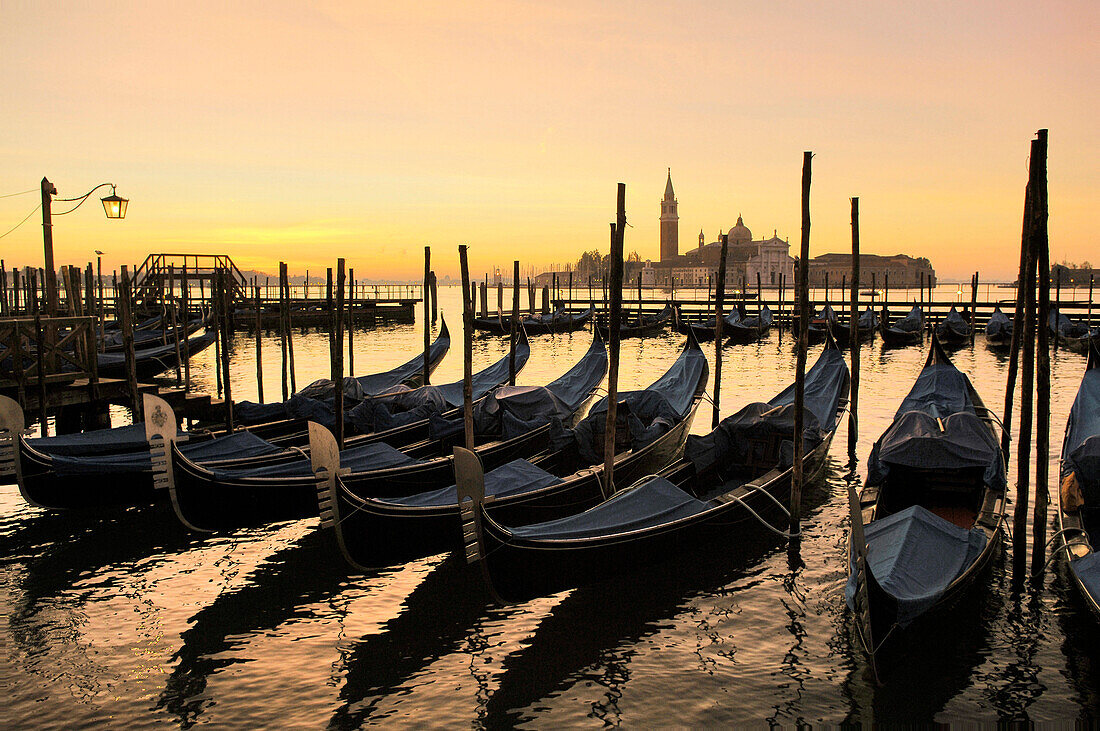 Gondola in a row and Isola San Giorgio in the background, Venice, Veneto, Italy